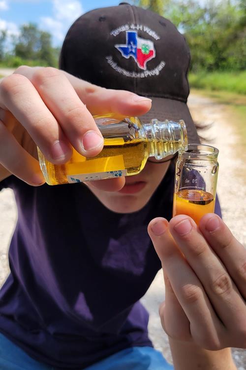 4-H student working with water samples by TWRI