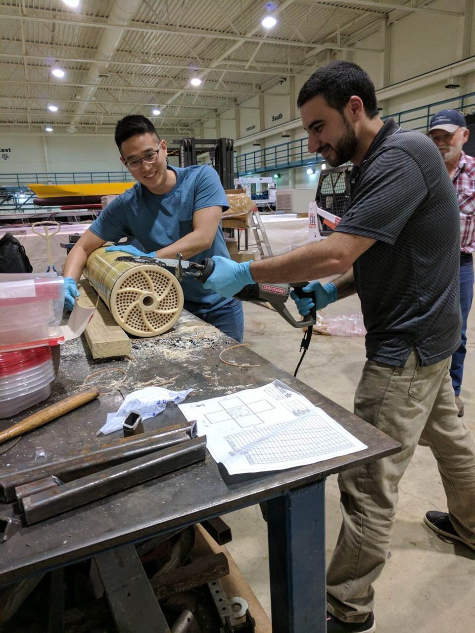 Doctorate students Kyungho Kim and Bilal Abada sacrifice a fouled spiral-wound membrane to conduct its autopsy.