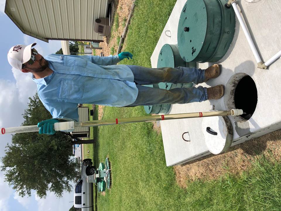 Ryan Gerlich, an AgriLife Extension OSSF team member, demonstrating how to take a sample from an ATU using a sludge judge device for a routine inspection. Photos by J. Wolfe.