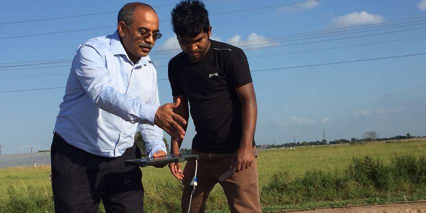 Ali Fares with a student in field
