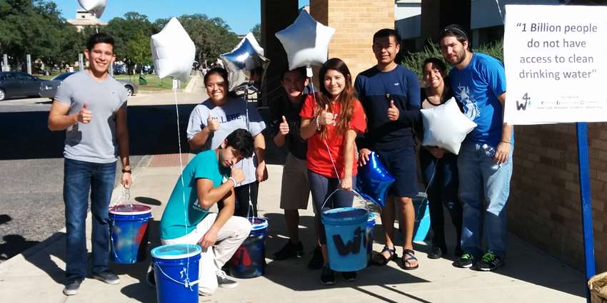 Texas A&M students walk with water buckets to raise awareness